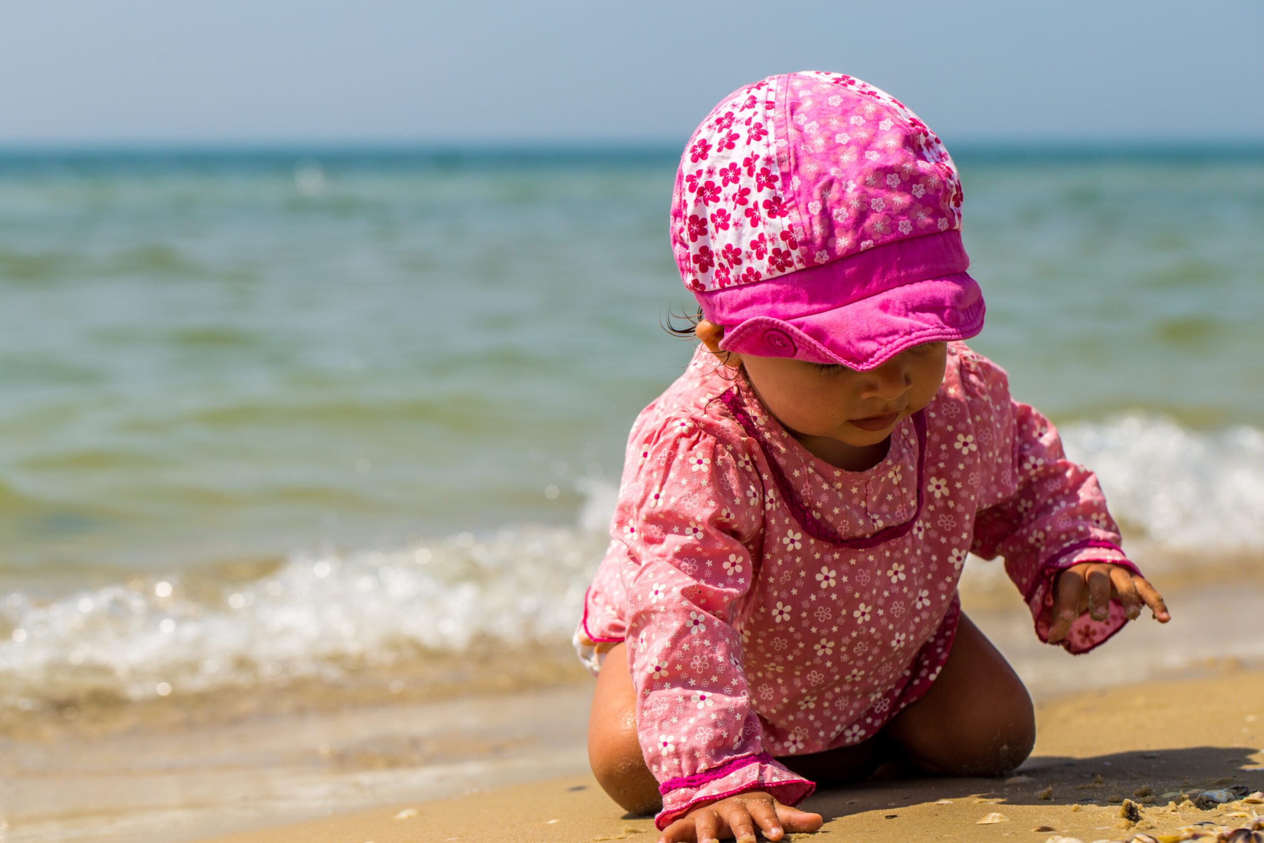 pretty little girl crawling beach joyful child emotions scaled